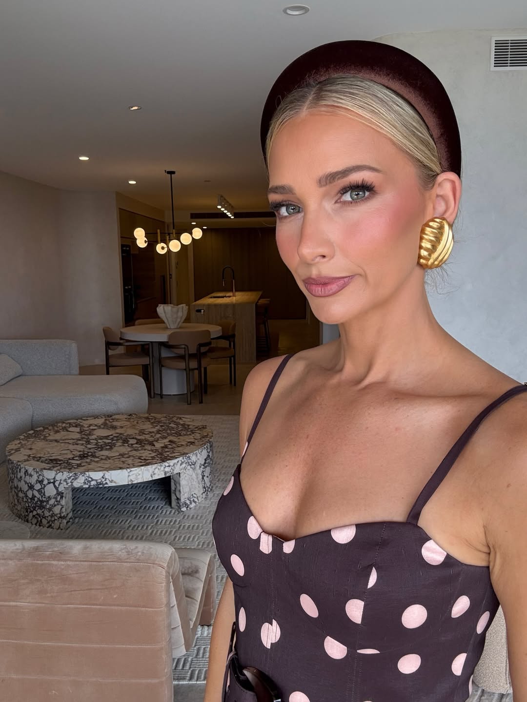 lady wearing a polka dot sundress teamed with a velvet brown headband