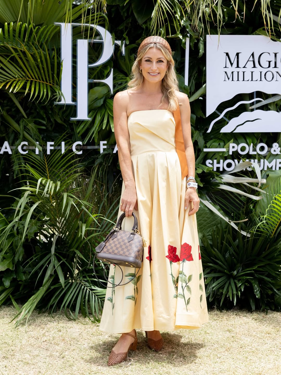 tv presenter liz cantor wears a yellow dress paired with our santorini woven headband with ribbons at magic millions polo 2026